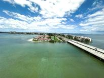 Beautiful aerial view of the coastal community, showing bridges and waterfront property under a bright blue cloudy sky at 5220 Brittany S Dr # 1306, St Petersburg, FL 33715