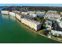 Expansive aerial view showcases waterfront condos and lush landscaping of the community with pristine water views at 6020 Shore S Blvd # 1008, Gulfport, FL 33707