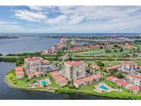 Stunning aerial view of waterfront condo community with pools, golf course, and views of the ocean at 6322 Palma Del Mar S Blvd # 1107, St Petersburg, FL 33715