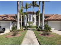Beautiful condo with a lovely walkway and palm trees, creating a welcoming entrance at 6715 Grand Estuary Trl # 203, Bradenton, FL 34212