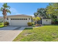 Charming single-story home featuring a well-maintained lawn and attached two-car garage at 7330 Fairwood Ave, New Port Richey, FL 34653