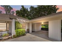 Charming home exterior featuring a covered carport and well-maintained landscaping at 9307 Golf View Dr, New Port Richey, FL 34655