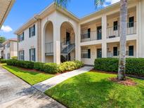 Charming condo exterior with manicured landscaping, private entrances, and a well-maintained facade at 10356 Carrollwood Ln # 204, Tampa, FL 33618