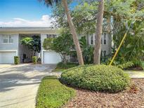Charming townhome featuring a white garage door and lush landscaping, creating curb appeal at 1211 W Horatio St # A, Tampa, FL 33606