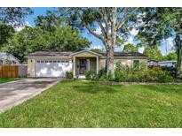 Charming single-story home with a well-manicured lawn and mature trees offering ample shade at 1524 Essex N Dr, St Petersburg, FL 33710