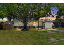 Charming single-story home featuring beautiful rock accents and a well-manicured lawn at 1851 Oklahoma Ne Ave, St Petersburg, FL 33703