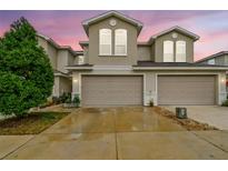 Inviting townhome featuring a spacious two-car garage and well-maintained landscaping at 1962 Marlington Way, Clearwater, FL 33763
