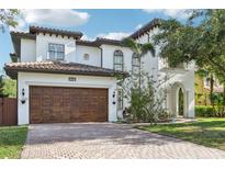 Stunning two-story home featuring a brick driveway and a beautiful arched entry at 3404 W Sevilla St, Tampa, FL 33629