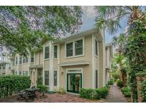Charming two-story townhome featuring a private brick patio, lush greenery, and a welcoming entrance at 350 2Nd N St # 1, St Petersburg, FL 33701