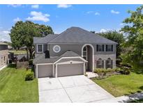 Beautiful two-story home with a three-car garage, well manicured lawn and beautiful landscaping at 9223 Brindlewood Dr, Odessa, FL 33556