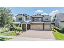 Inviting two-story home with a three car garage and manicured landscaping at 10313 Scarlet Chase Dr, Riverview, FL 33569