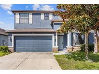 Beautiful two-story home featuring a two-car garage and well-manicured lawn at 10808 Whitecap Dr, Riverview, FL 33579