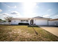 Charming single story home with an attached garage and well-maintained front lawn at 11071 141St St, Largo, FL 33774