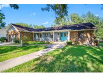 Charming single story home featuring stone accents, a cozy front porch, and well-manicured lawn at 11109 Winn Rd, Riverview, FL 33569