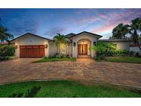 Charming single-Gathering home featuring a brick driveway, attached garage, and a well-manicured lawn at 132 Giralda Ne Blvd, St Petersburg, FL 33704