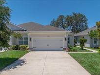 Charming one-story home featuring a manicured lawn and a two-car garage at 1528 Highland Park Dr, Clearwater, FL 33756