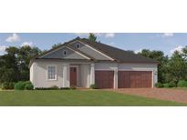 Charming single-story home with a brick driveway, stucco exterior, gray trim, and a two-car garage at 31602 Cardinal Yard Dr, San Antonio, FL 33576