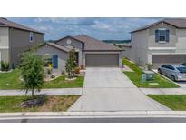 Charming single-Gathering home with a well-manicured lawn and a two-car garage at 31775 Sun Kettle Loop Loop, Wesley Chapel, FL 33545