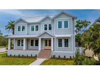 Beautiful two-story home with a metal roof, covered porch, and well-maintained landscaping at 4311 W Sevilla St, Tampa, FL 33629