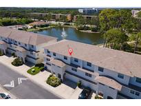 Beautiful aerial view highlighting townhome complex with lake, fountain, and manicured grounds at 8181 Eagles Park N Dr, St Petersburg, FL 33709