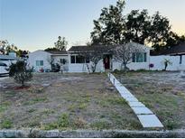 Charming single-story home featuring a well-manicured lawn and inviting walkway at 910 Robinson N Dr, St Petersburg, FL 33710