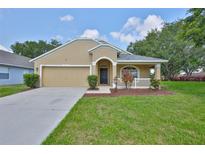 Charming single-story home with a well-manicured lawn and inviting front porch at 11726 S Stone Ln, Riverview, FL 33569