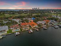 Waterfront home featuring a private dock and pool, offering stunning city views at sunset at 301 Bayview Ne Dr, St Petersburg, FL 33704