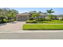 Charming single-story home featuring a brick driveway and well-manicured landscaping and lawn at 3402 Stonebridge Trl, Valrico, FL 33596