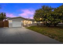 Charming single-story home with attached garage, lush lawn, and mature tree at 3485 Floral Dr, Largo, FL 33771