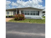 Charming single-story home featuring a carport and well-maintained lawn at 37832 Madeira Ave, Zephyrhills, FL 33541