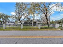 Elegant home featuring a well manicured front yard and an iron perimeter fence at 4641 John Moore Rd, Brandon, FL 33511