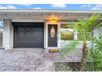 Close up of front door and garage, highlighting the paved driveway and landscaping at 4726 W Fairview Hts, Tampa, FL 33616