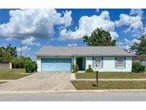 Charming one-story home with a well-maintained lawn, blue garage, and light blue shutters at 502 Chilt Dr, Brandon, FL 33510