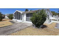 Charming single-story home with a well-maintained yard and screened in porch at 5031 Billings Dr, Holiday, FL 34690