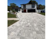 Two-story home with a large driveway and well-maintained lawn in a quiet neighborhood at 7312 Nova Cir, Tampa, FL 33634