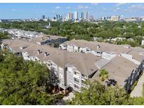 An aerial view showing the multi-story condo building and city skyline at 800 S Dakota Ave # 337, Tampa, FL 33606