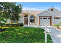 Charming single-story home featuring a well-manicured lawn and inviting curb appeal on a sunny day at 9314 Alta Sol Way, New Port Richey, FL 34655