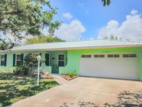 Charming single-story home features a bright exterior, manicured lawn, and an attached garage at 1022 Greenbriar Dr, Brandon, FL 33511