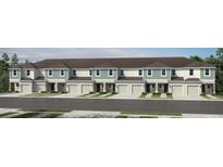 Exterior view of townhomes featuring a two-car garage, modern trim, and manicured lawns at 13248 Stable Pl, Parrish, FL 34219