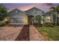 Charming single-Gathering home featuring a brick driveway and lush landscaping at 212 Shell Creek Ct, Apollo Beach, FL 33572