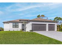 Charming single-story home featuring a two-car garage, lush lawn, and a modern design at 2414 Hiers Rd, Dover, FL 33527