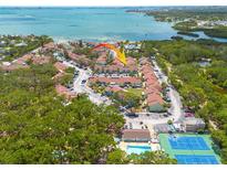 Aerial view of the condo community, showcasing beautiful landscaping, swimming pool, tennis courts and waterfront views at 3595 41St S Ln # L, St Petersburg, FL 33711