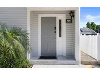 Stylish gray front door with sidelight and modern lock system provides secure and convenient access at 500 New York Ave # 23, Dunedin, FL 34698
