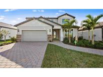 Charming two-story home featuring a two-car garage, brick-paver driveway, and well-manicured lawn at 5634 Clearwater Ct, Lakewood Ranch, FL 34211