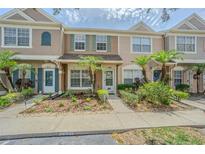 Charming townhome exterior with landscaped walkway and inviting entrance at 6229 Bayside Key Dr, Tampa, FL 33615