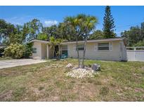 Charming single-story home features a stucco facade, well-kept landscaping and a vibrant, inviting exterior at 11486 92Nd N St, Largo, FL 33773