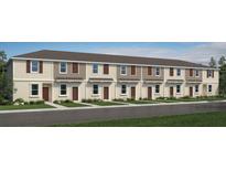 New townhouse showcases charming curb appeal with symmetrical design and neutral color palette at 14040 Textile Run, Parrish, FL 34219
