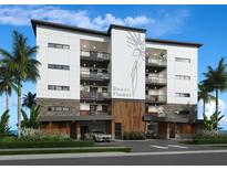 Modern condo building with balconies, stone accents, wood details and lush landscaping at 14048 Gulf Blvd # 302, Madeira Beach, FL 33708