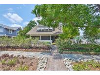 Charming home with lush landscaping and a welcoming walkway to the front porch at 1825 2Nd S St, St Petersburg, FL 33705