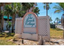 The Beach Cottage II sign with palm trees against a blue sky at 18400 Gulf Blvd # 2505, Indian Shores, FL 33785